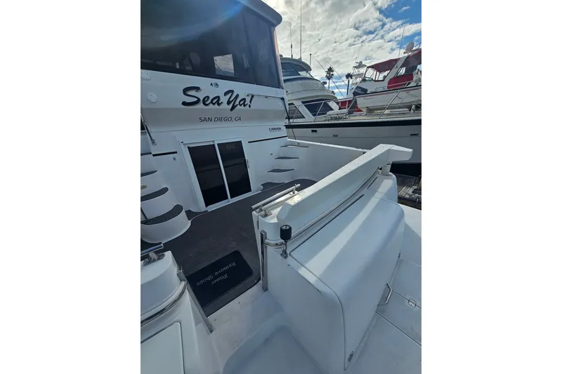 Slide: The Image of 2001 Carver 564 Cockpit Motor Yacht docked in San Diego, featuring spacious deck area. - 39