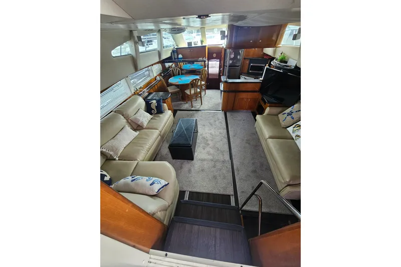Slide: The Image of Luxurious interior of 2001 Carver 564 Cockpit Motor Yacht with plush seating and modern amenities. - 51