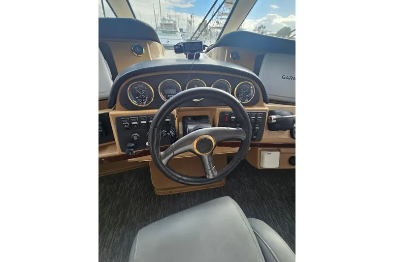 Slide: The Image of 2001 Carver 564 Cockpit Motor Yacht helm with steering wheel and instrument panel. - 46