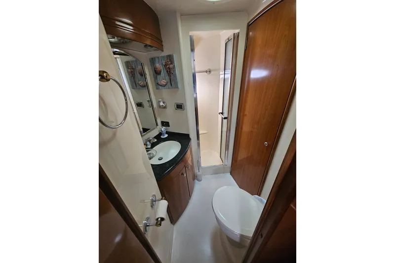 Slide: The Image of Luxurious bathroom in 2001 Carver 564 Cockpit Motor Yacht with modern amenities. - 20