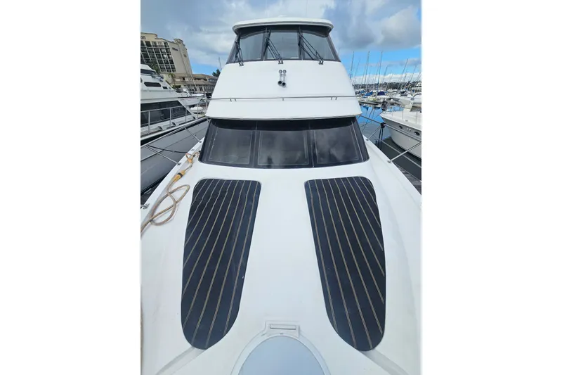 Slide: The Image of 2001 Carver 564 Cockpit Motor Yacht docked at marina, front view. - 34