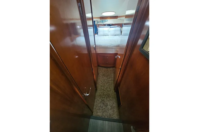 Slide: The Image of Interior hallway of 2001 Carver 564 Cockpit Motor Yacht with wood paneling and carpet. - 14