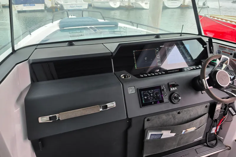 Slide: The Image of Cockpit of 2022 Axopar 37 XC Cross Cabin with modern navigation controls. - 10