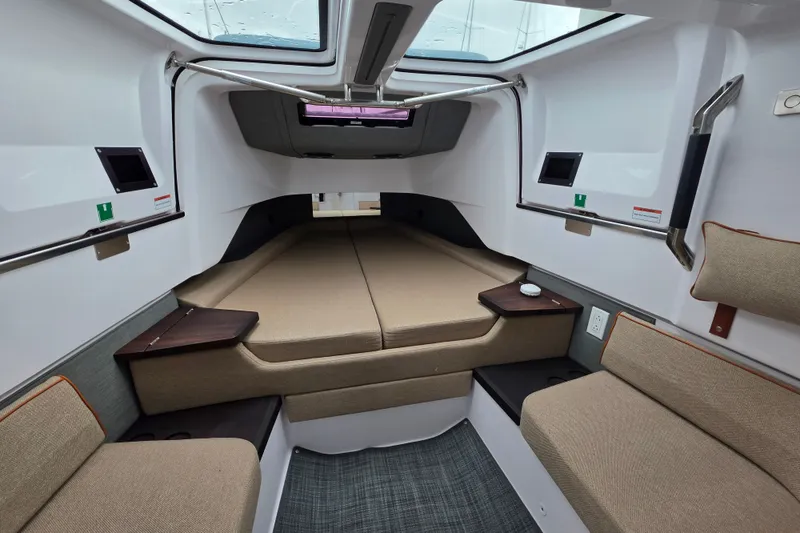 Slide: The Image of Interior of 2022 Axopar 37 XC Cross Cabin, featuring cozy seating and modern design. - 14