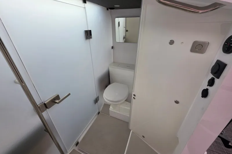 Slide: The Image of Bathroom interior of 2022 Axopar 37 XC Cross Cabin, featuring modern fixtures and compact design. - 15