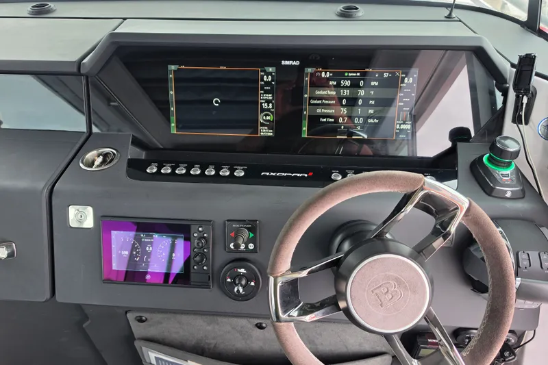 Slide: The Image of 2022 Axopar 37 XC Cross Cabin dashboard with advanced navigation and control systems. - 9