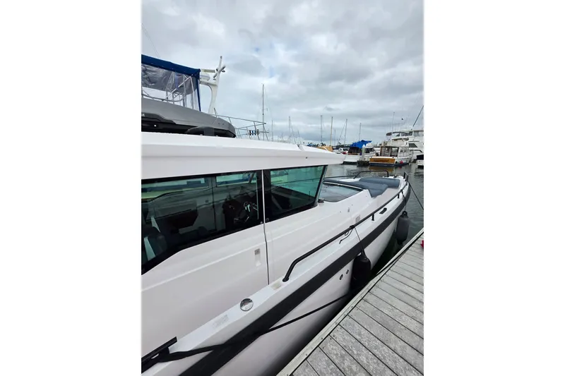 Slide: The Image of 2022 Axopar 37 XC Cross Cabin docked at a marina under cloudy skies. - 8