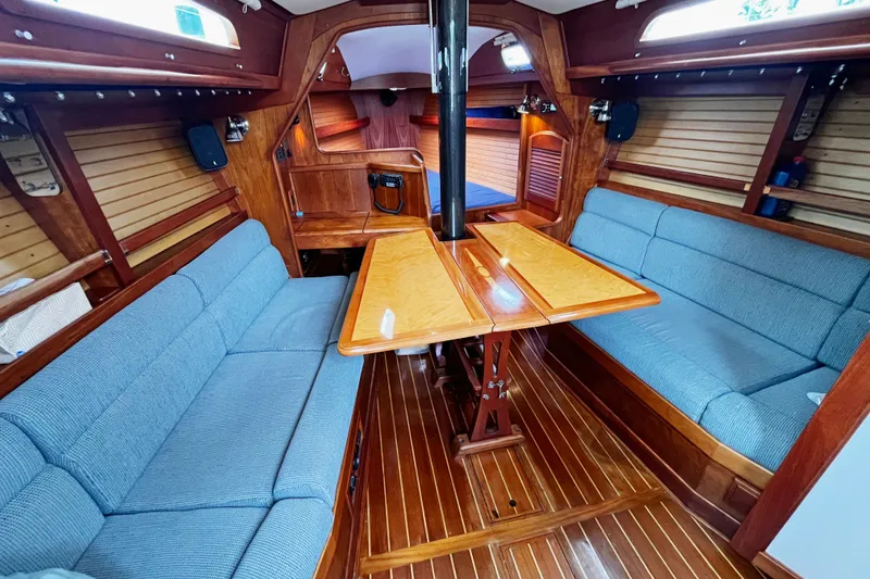 Slide: The Image of Interior of a 2007 Sabre Spirit sailboat with wooden finishes and blue seating. - 30