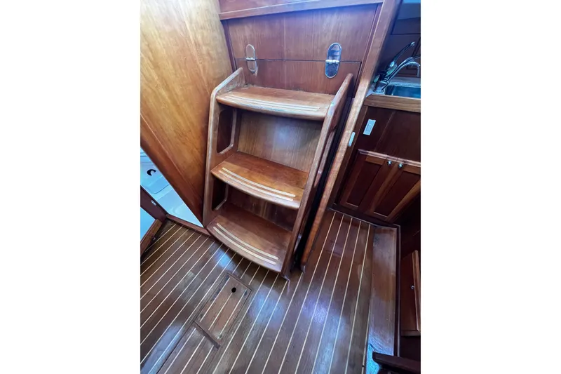 Slide: The Image of Wooden interior stairs of a 2007 Sabre Spirit sailboat, showcasing elegant craftsmanship. - 35
