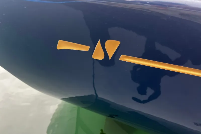 Slide: The Image of Blue Sabre Spirit 2007 boat hull with gold emblem detail. - 23