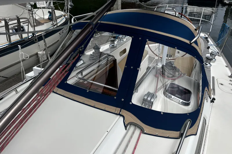 Slide: The Image of 2007 Sabre Spirit sailboat with blue canopy and deck details in marina setting. - 16