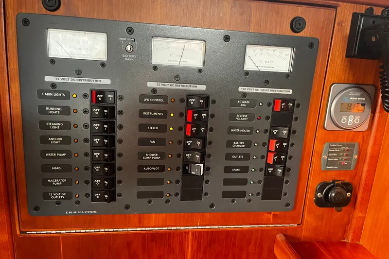 Slide: The Image of Electrical control panel on a 2007 Sabre Spirit boat, featuring various switches and gauges. - 38