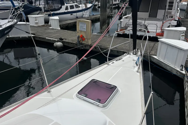 Slide: The Image of 2007 Sabre Spirit sailboat docked at marina, featuring sleek deck and vibrant red ropes. - 18
