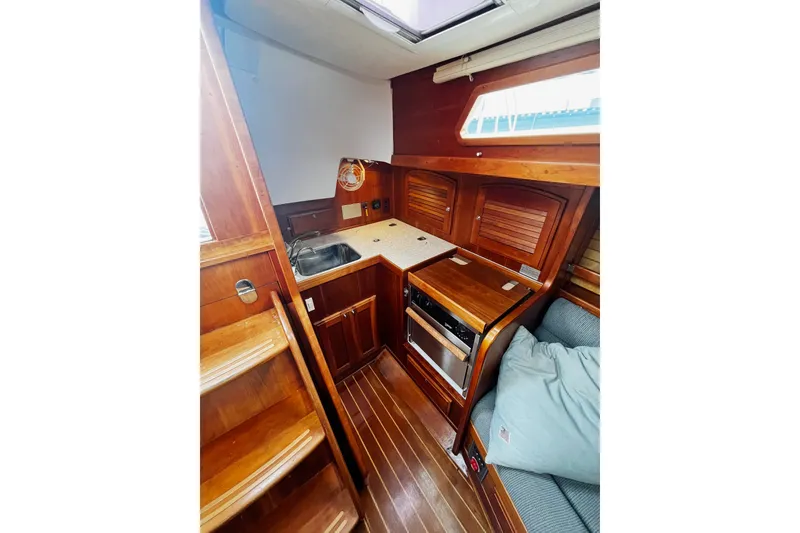 Slide: The Image of 2007 Sabre Spirit yacht interior with wooden cabinetry and compact kitchen area. - 31