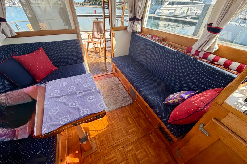 Slide: The Image of Interior of a 1975 Grand Banks 32 Sedan with cozy seating and nautical decor. - 7