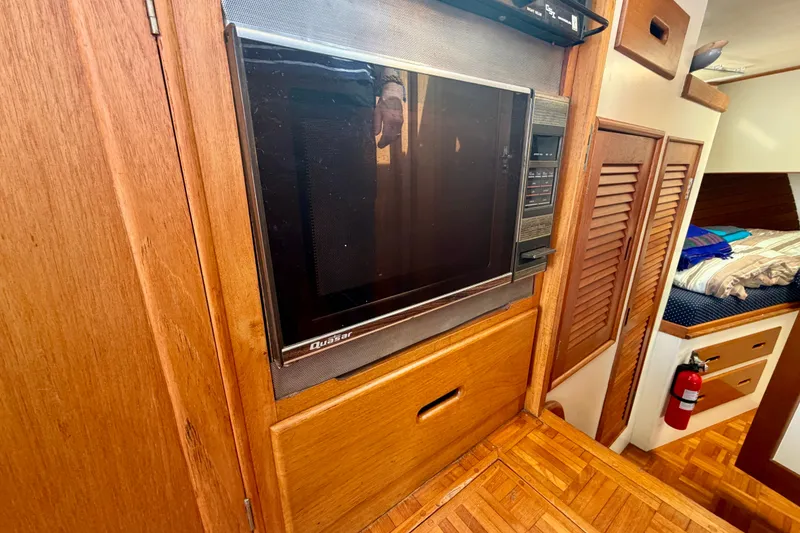 Slide: The Image of 1975 Grand Banks 32 Sedan interior with vintage Quasar TV and wooden cabinetry. - 19
