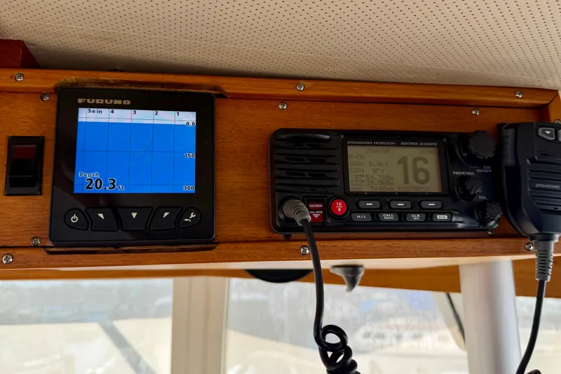 Slide: The Image of 1975 Grand Banks 32 Sedan dashboard with Furuno depth gauge and Standard Horizon radio. - 11