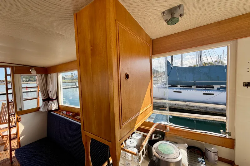 Slide: The Image of Interior of a 1975 Grand Banks 32 Sedan boat with wooden cabinetry and marina view. - 18