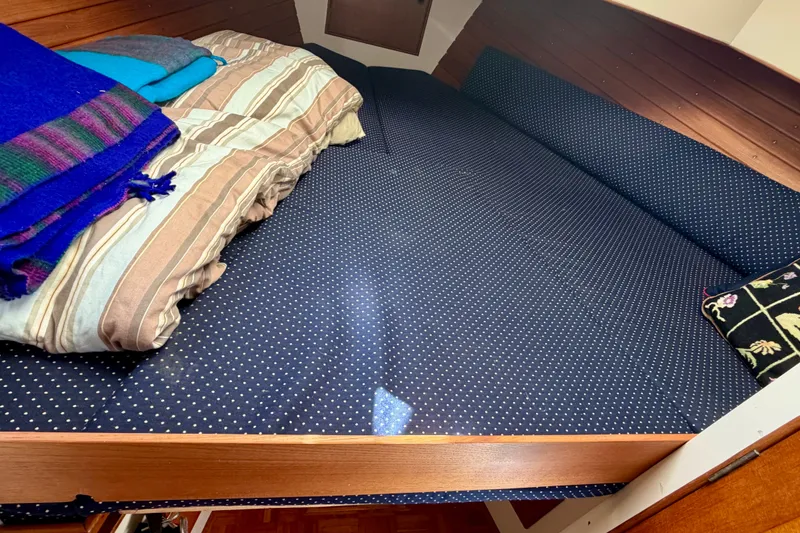 Slide: The Image of Cozy cabin bed in 1975 Grand Banks 32 Sedan with polka dot bedding. - 22