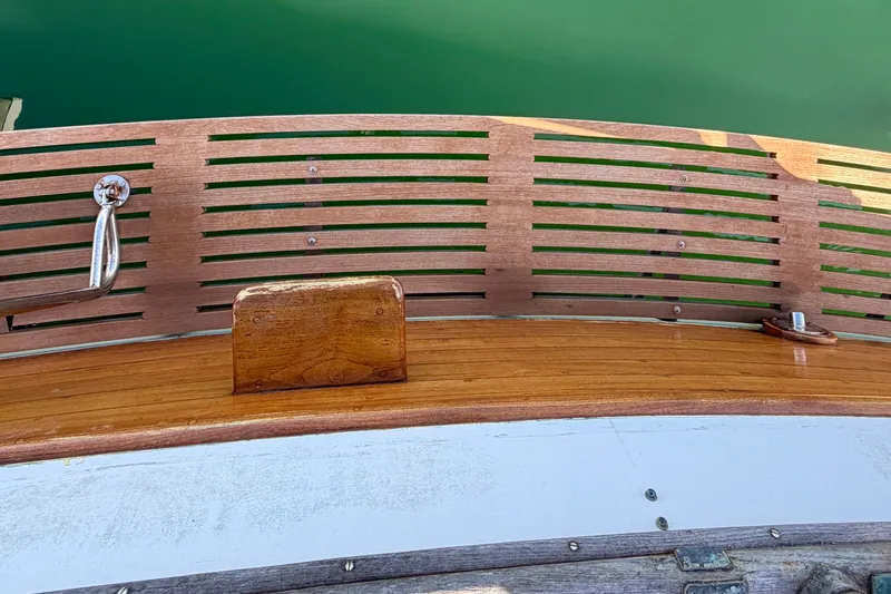 Slide: The Image of Wooden deck detail of a 1975 Grand Banks 32 Sedan boat, featuring polished fittings. - 6