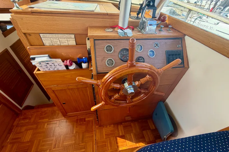 Slide: The Image of Interior helm of a 1975 Grand Banks 32 Sedan with wooden steering wheel and gauges. - 14