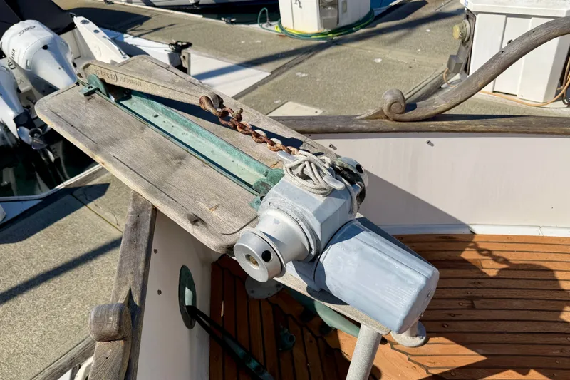 Slide: The Image of 1975 Grand Banks 32 Sedan anchor windlass on wooden deck, showcasing nautical equipment. - 26