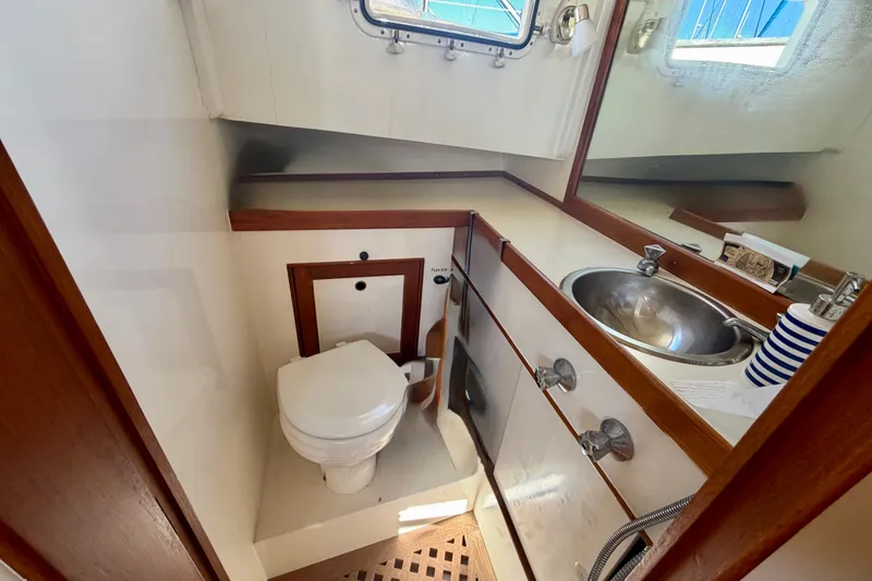 Slide: The Image of 1975 Grand Banks 32 Sedan bathroom with toilet, sink, and mirror. - 20