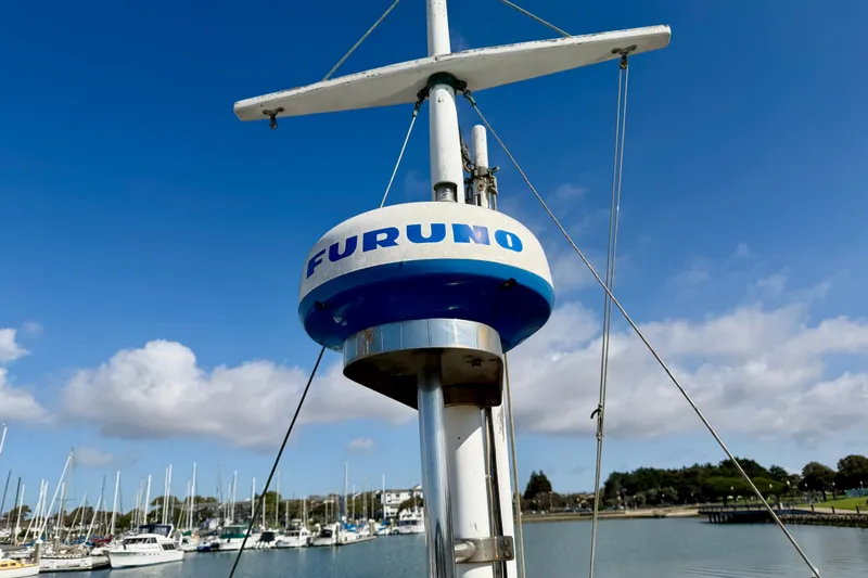 Slide: The Image of Radar equipment on a 1975 Grand Banks 32 Sedan boat in a marina. - 12