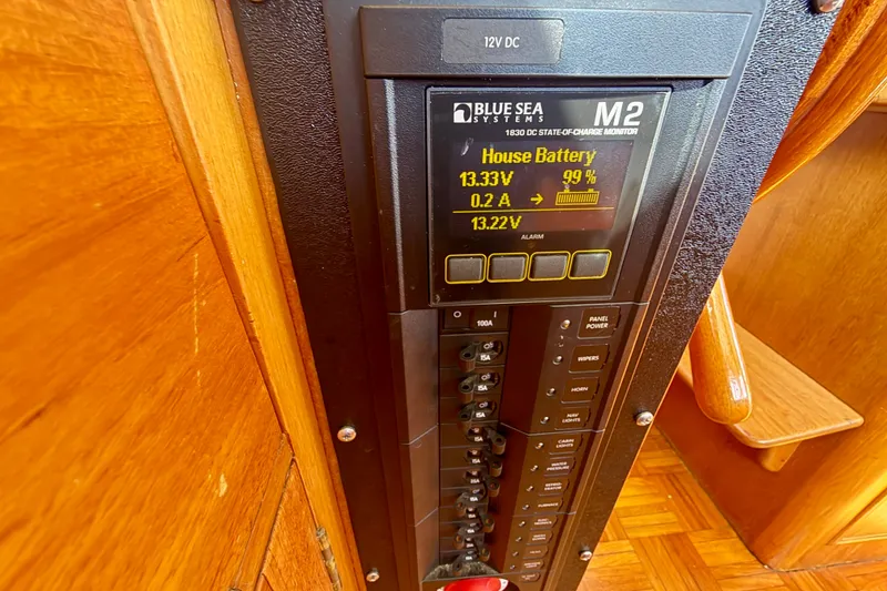 Slide: The Image of Electrical panel on a 1975 Grand Banks 32 Sedan, showing battery status and controls. - 25