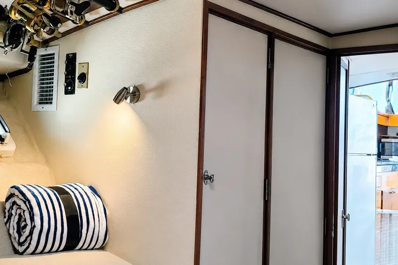 Slide: The Image of Interior of 1981 Bertram 46.6 yacht with striped towel and fishing rods. - 24