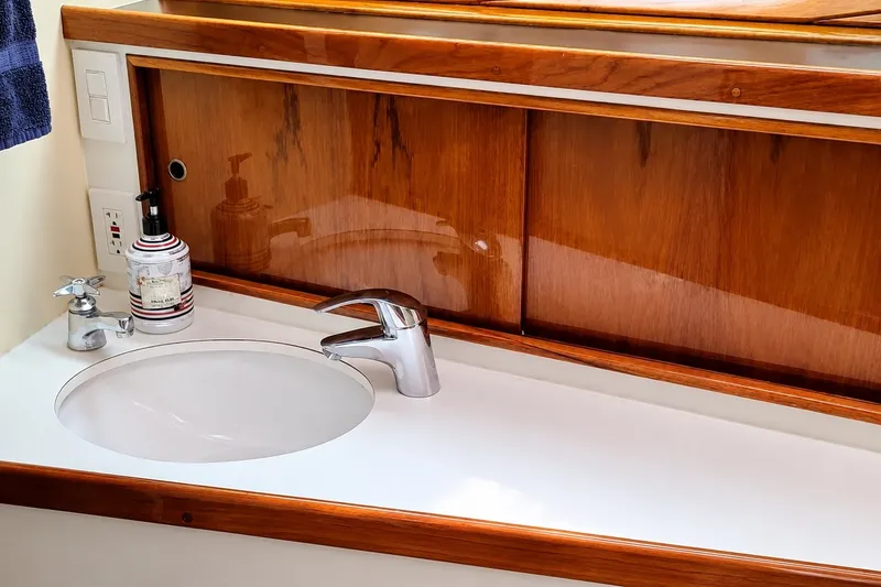 Slide: The Image of Elegant wooden vanity with modern sink on 1981 Bertram 46.6 yacht. - 15