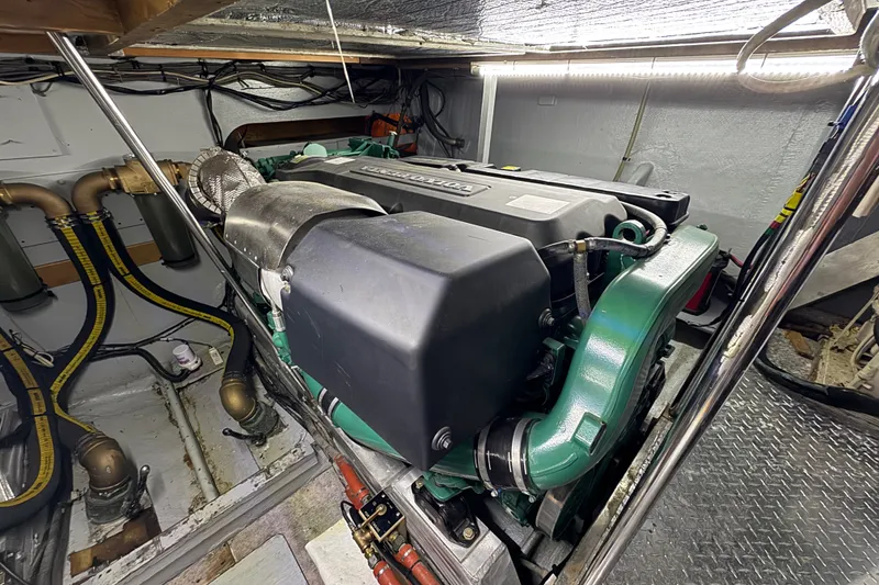 Slide: The Image of Engine room of a 1981 Bertram 46.6 yacht, showcasing a well-maintained engine. - 33