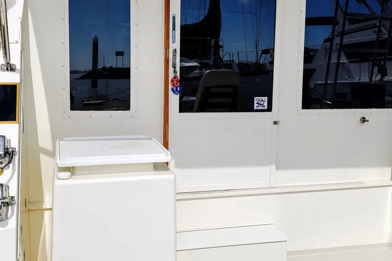 Slide: The Image of 1981 Bertram 46.6 yacht exterior with marina reflections on windows. - 5
