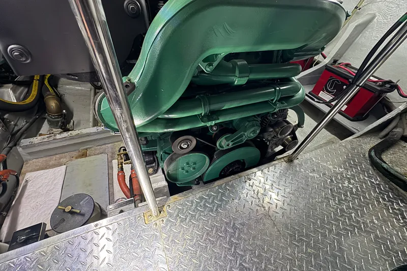 Slide: The Image of Engine room of a 1981 Bertram 46.6 yacht, featuring a green marine engine. - 34