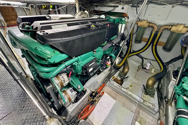 Slide: The Image of Engine room of a 1981 Bertram 46.6 yacht, showcasing a well-maintained marine engine. - 32