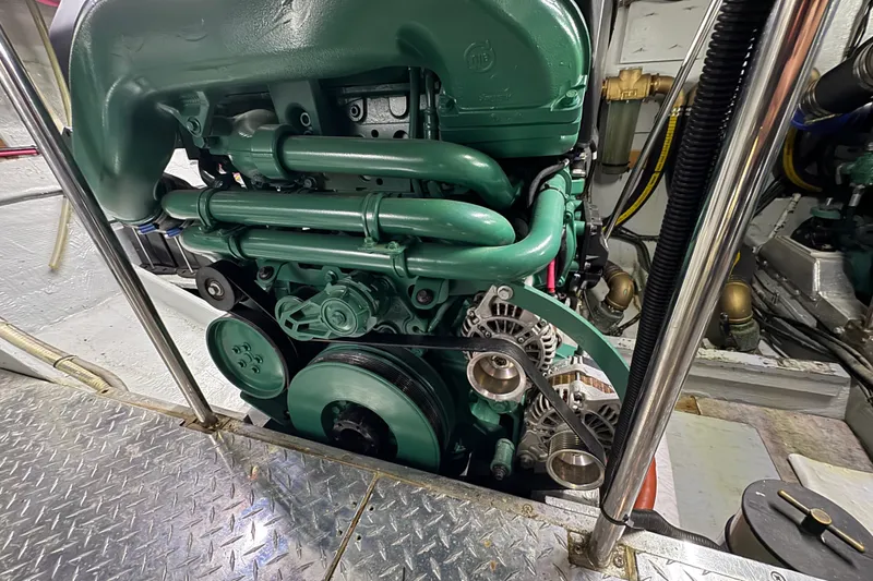 Slide: The Image of Engine room of a 1981 Bertram 46.6 yacht, showcasing a detailed view of the engine components. - 38
