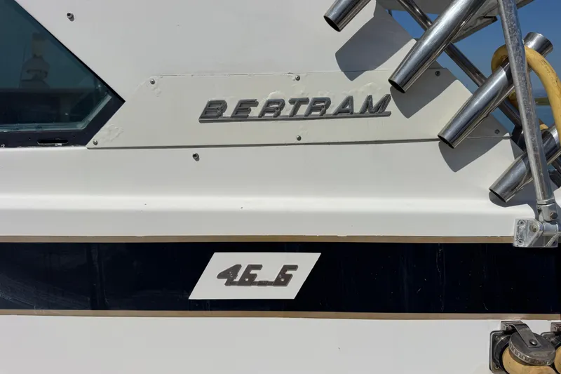 Slide: The Image of 1981 Bertram 46.6 boat exterior with logo and model details. - 40