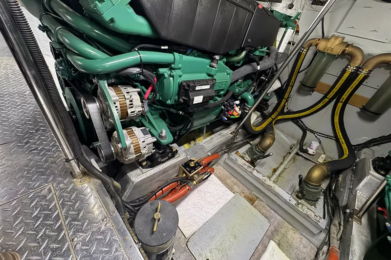Slide: The Image of Engine room of a 1981 Bertram 46.6 yacht, featuring a green marine engine. - 35
