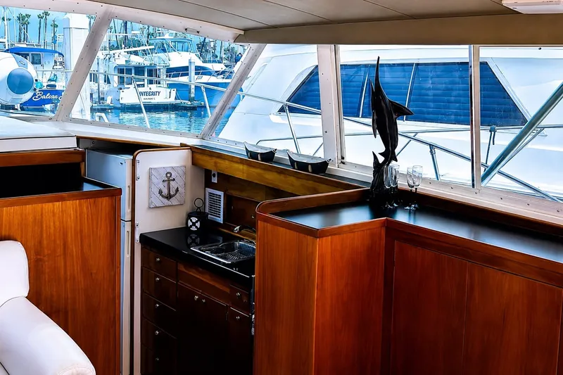 Slide: The Image of Interior of a 1981 Bertram 46.6 yacht with wooden cabinetry and marina view. - 7