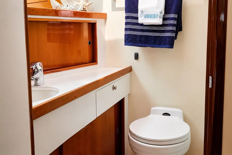 Slide: The Image of 1981 Bertram 46.6 yacht bathroom with wooden cabinetry and modern fixtures. - 16