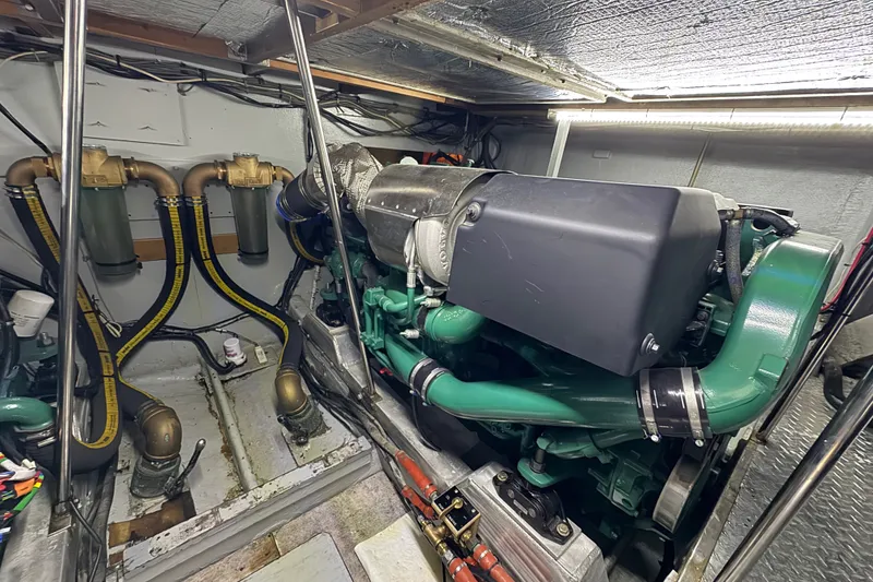 Slide: The Image of Engine room of a 1981 Bertram 46.6 yacht, showcasing detailed mechanical components. - 37