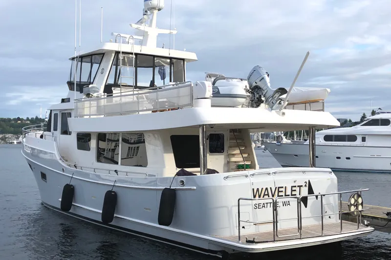 Slide: The Image of 2011 Ocean Alexander 60 Trawler docked, featuring spacious deck and modern design. - 3