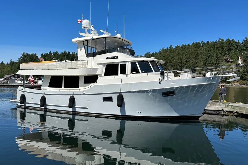 Slide: The Image of 2011 Ocean Alexander 60 Trawler yacht docked in a serene marina setting. - 4