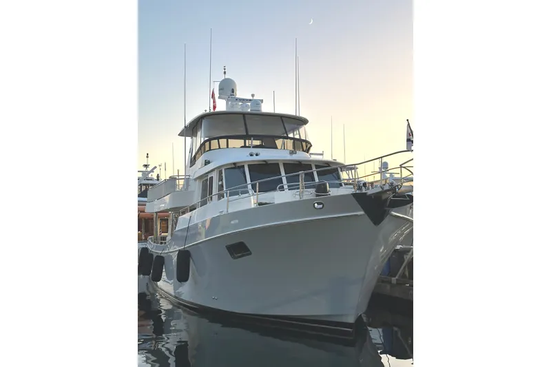 Slide: The Image of Ocean Alexander 60 Trawler 2011 docked at sunset, showcasing sleek design and modern features. - 2