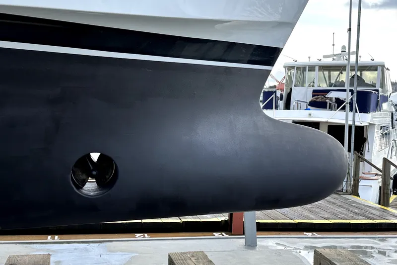 Slide: The Image of Close-up of 2011 Ocean Alexander 60 Trawler hull with bow thruster, docked at marina. - 9