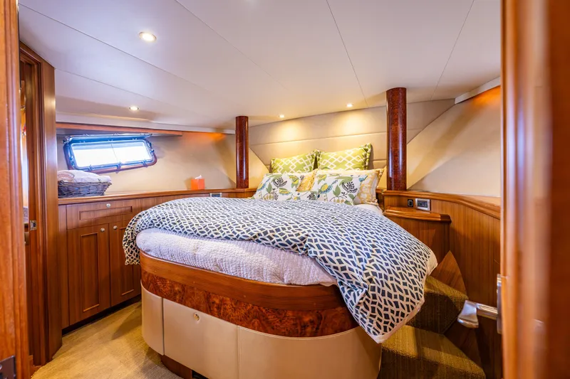 Slide: The Image of Luxurious cabin interior of 2011 Ocean Alexander 60 Trawler with cozy bedding and wood finish. - 95