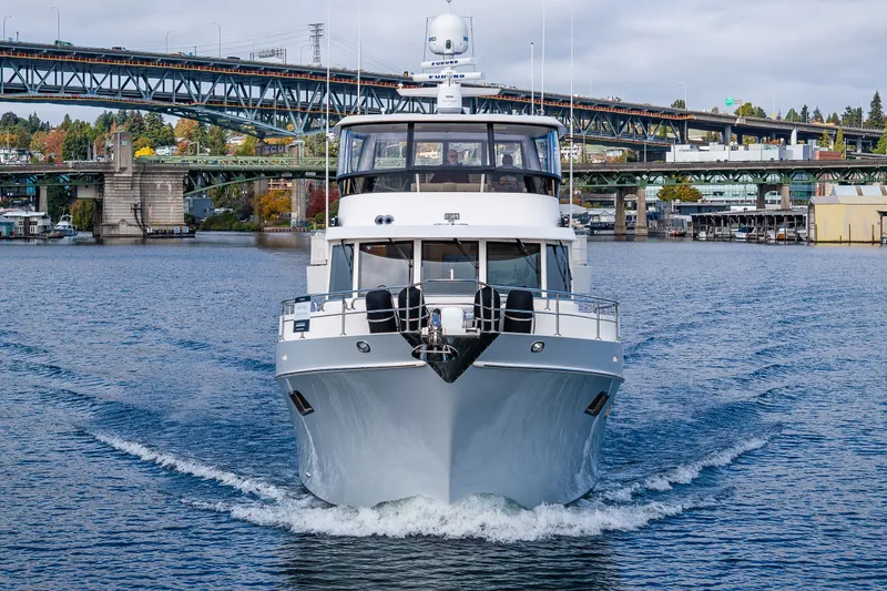 Slide: The Image of 2011 Ocean Alexander 60 Trawler cruising under a bridge on a scenic waterway. - 24