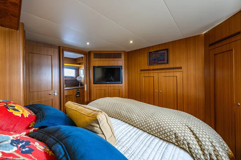 Slide: The Image of Luxurious cabin interior of 2011 Ocean Alexander 60 Trawler with wood paneling and cozy bedding. - 86