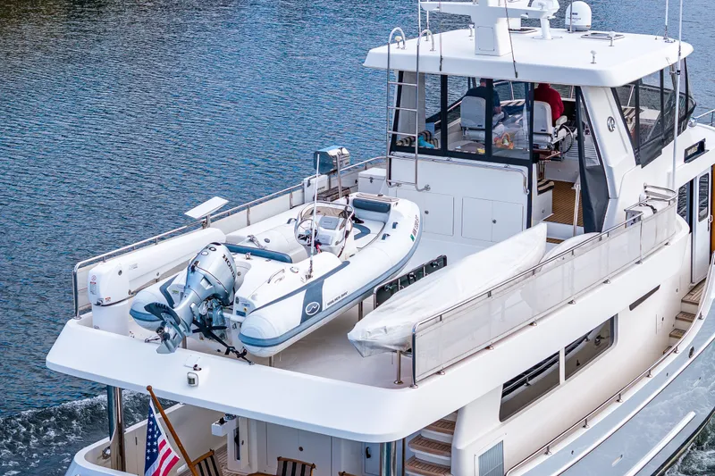 Slide: The Image of Ocean Alexander 60 Trawler 2011 with dinghy on deck, cruising on calm waters. - 20