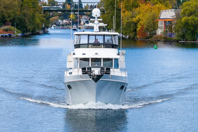 Slide: The Image of 2011 Ocean Alexander 60 Trawler cruising on a scenic river with autumn foliage. - 18